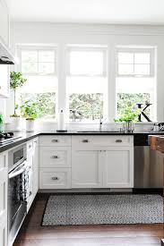 Furthermore one of the greatest advantages of having white shaker cabinets is their ability to help you with cleaning. Black And White Kitchen Features White Shaker Cabinets Accented With Cup Pulls And Topped With Black Coun Kitchen Design Craftsman Kitchen Kitchen Inspirations