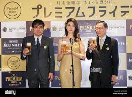 L to R) Manager Makoto Asaka of Ginza Mitsukoshi, actress Manami Hashimoto  and Suntory Holdings' Vice President Yasunori Aiba pose for cameras during  the Premium Friday opening ceremony on February 24, 2017,