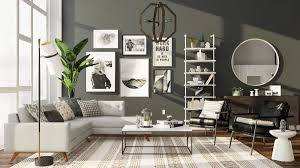The matte black accent wall centers the living space, a suspended credenza and shelf unit sharing the spotlight with a bold canvas. 4 Designer Approved Black And White Living Room Ideas Modsy Blog