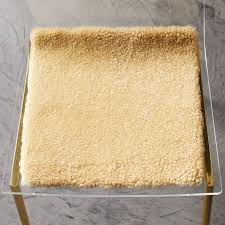 The cushion covers are dope dyed, a process that reduces consumption of water and dyestuff while improving color fastness compared to traditional dyeing techniques. Camel Sheepskin Chair Pad Reviews Cb2