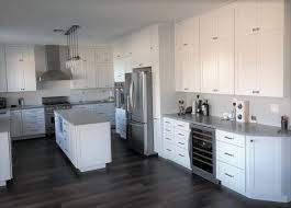 Featuring stainless steel appliances, porcelain farm sink, custom made wood hood, pendant lights, and bar stools along with white subway tile backsplash completed the kitchen. The Correct Countertop Is Key Kitchen Mart