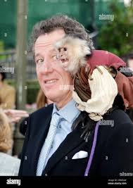 Geoffrey Rush poses with a monkey