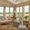 Dark stained porch flooring, white furniture and walls, and a jute rug provide a neutral backdrop.bright accents, including floral cushions and tabletop accessories, keep the seasonal space sunny and bright. 3
