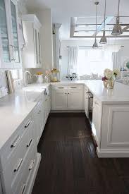 Kitchen Peninsula White Kitchen With Peninsula Perimeter Kitchen Counters Are Caesarsto Wood Floor Kitchen White Cabinets White Countertops White Countertops