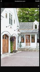 Black And White House With Wood Garage Door Pin By Madison May On Garage Modern Farmhouse Exterior House Exterior Farmhouse Exterior