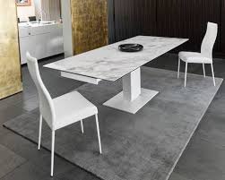 The top is veneered in walnut curl in a starburst formation with six lines of symmetry. 20 Expandable Tables You Ll Need For Social Gatherings 2modern