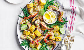 Decorated christmas tree in the background. Seafood Christmas Menu Coles