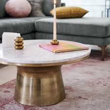 Stainless steel, marble and brass are the materials of choice Buy Online Marble Topped Pedestal Coffee Table White Marble Antique Brass Now West Elm Uae