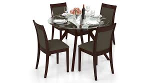 Stylifing dining table and chairs set round clear glass top crisscrossing chrome metal legs kitchen table and 4 sled based grey faux leather chairs dining set home kitchen office waiting room use. Urban Ladder Wesley Dalla 4 Seater Round Glass Top Dining Table Set Colour Grey Finish Dark Walnut Amazon In