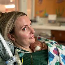 On any given day in the neonatal intensive care unit (NICU) at Lucile  Packard Children's Hospital Stanford, a parent leans back in a recliner  with a newborn nestled
