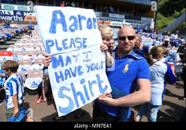 A Huddersfield Town fan holds a sign reading 'Aaron please may I have your  shirt' prior to the match Stock Photo