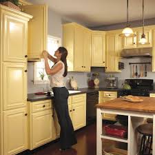 Otherwise, use small foam rollers for the cabinet surfaces that remain in the house. How To Spray Paint Kitchen Cabinets Diy Family Handyman