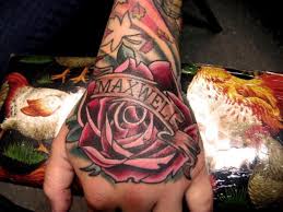 By adding a diamond which stands for prosperity. Hand Rose Name Tattoo By Proton Tattoo