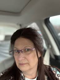 A little girl with a bow in her hair wearing a tutu.