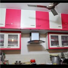 The red upholstered dining chairs and deep blue painted island and cabinets are so rich and sophisticated, they almost blend in with the dark wood cabinets. White And Red Pvc Kitchen Cabinet Rs 350 Square Feet Ramdev Pvc Furniture Id 21462013297