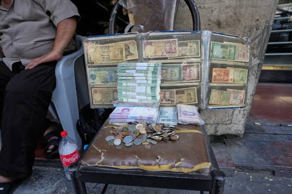 Iran's rial currency hits new record low of more than 2 million to the dollar | AP News