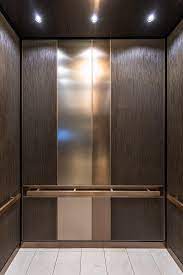 levele 101 elevator interior capture panels in bonded bronze with dark patina and grass pattern fused elevator lobby design elevator design elevator interior