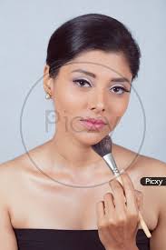 female model with a makeup brush