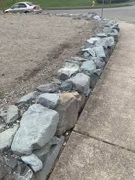 Rock wall landscaping ideas, rock walls look better than ever retaining walls desert landscape ideas and garden shop pavers and get pretty expensive depending on. How Do I Transition From Grass To Rock Wall This Is Corner Of Front Yard There Is Gravel In Between The Top Rock Wall Rocks Landscaping