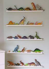15 Unexpected Ways To Decorate With Collections The Finishing Touch Dinosaur Boys Room Boys Bedroom Storage Dinosaur Room