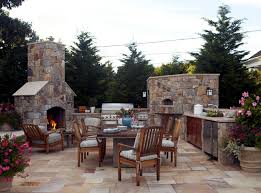 If the only area available for the creation of the barbecue is covered with a brick in sight, place a stove and refrigerator to make it look like an integrated and to share the ambiance, use a high counter with a wood, marble or glass top with tall stools to give it a bar feel. Stone Barbecue Fireplace The Highlight In The Garden Interior Design Ideas Ofdesign