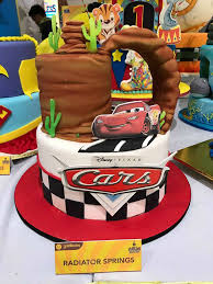 Layers of chocolate, vanilla and ppersonalized banner and cookie cupcake toppers with photo. Batman Cake Design Goldilocks