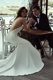 A trumpet lace halter neckline wedding dress with an illusion sweteheart neckline and a train. Jewel Wedding Dresses Justin Alexander