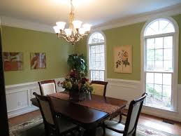 A pale blue rug grounds the space in serene color. Emerald Light Green Dining Room Acthere