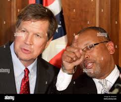 Harvey Reed, right, points out members of his family to Ohio Gov. John  Kasich at a news conference, Tuesday, March 1, 2011, in Cincinnati. Gov.  Kasich announced the appointment of Reed as