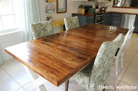 Chair fabric is worn and the table has a visible burn from a candle. Pecan Farmhouse Dining Table Domestic Imperfection