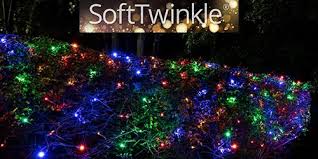 Christmas lights in netting across the trees outside walthamstow central. Net Lights And Tree Wraps