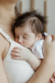 A woman holding a baby in her arms photo