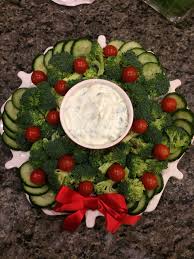 I love the looks of anticipation. Broccoli Cucumber And Tomato Wreath For Tim S Work Potluck Christmas Recipes Appetizers Christmas Food Christmas Party Food
