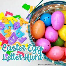 Decorated easter egg hunt with painted easter eggs in a row sitting on green grass on a whiote background as a symbol of spring and a holiday decoration and design element of the renewal season. Easter Egg Letter Hunt Messy Little Monster
