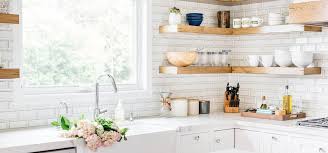 White and gray marble chevron pattern backsplash in a red kitchen boasting white quartz countertops for a sleek and balanced finish. Designer Tile Ceramic Stone Porcelain Mosaics Glass Accessories Ann Sacks