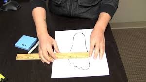 Podiatrist lindsay hill fitting shoes for her son (image: How To Measure Your Feet At Home Youtube