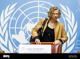 Inger Andersen, Executive Director of the United Nations Environment  Programme (UNEP), drives for a news conference about the UNEP's annual  Emissions Gap report at the European headquarters of the United Nations in