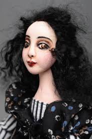 Self-hardening clay doll in black dress