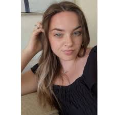 What is a Baltimore Oriole trying to do when pecking at a picture window?