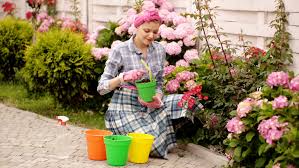 Planting flowers is one of the least expensive ways to make your house look inviting. Girl Gardening Outside Garden Scene Stock Footage Video 100 Royalty Free 1066677505 Shutterstock