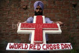 Image of may 8 calendar on floral background with flowers, empty space for text. World Red Cross Day Cross In Hand