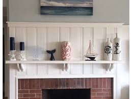 Apply paint primer to the fireplace bricks using a large paintbrush. Brick Fireplace Color