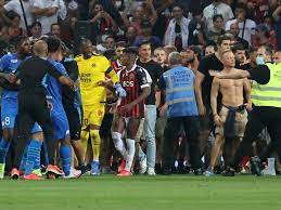 Punches are exchanged in an ugly brawl involving players and fans during the ligue 1 game between nice and marseille at the allianz riviera stadium in nice, france, august 22, 2021. 1mmpzw6zdmtc9m