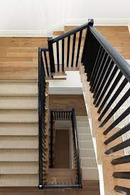 Black Wooden Staircase With Spindles Accent An Oak Staircase Featuring A Light Gray Herringbone Stair Wooden Staircase Railing Wooden Staircases Oak Staircase
