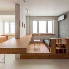 The Bed Is Built Into A Raised Platform And Is Hidden From View By A Grid Of Shelving A Series Of Dra Minimalist Apartment Built In Furniture Apartment Design