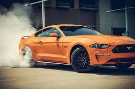 2018 Mustang Gt In Orange Fury Tri Coat Doing A Burnout With Smoke Surrounding The Rear Tires Sports Car Photos 2018 Mustang Gt Ford Mustang