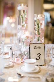 Floating Candle Centerpieces With Blush Orchids And Rose Gold Table Linens Candle Wedding Centerpieces Wedding Candles Table Blush Wedding Centerpieces