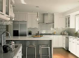 This Transitional L Shaped Kitchen Layout Features A Modern Design With White Grey Cabi Contemporary Kitchen White Kitchen Backsplash White Kitchen Furniture