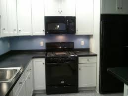 white kitchen cabinets with black