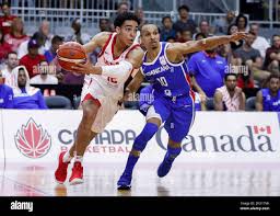Canada's Andrew Nembhard goes to the basket against Dominican Republic's  Rigoberto Adris Geraldo De Leon Jimenez, right, during a FIBA basketball  World Cup qualifier game in Toronto, Friday, June 29, 2018. (Mark